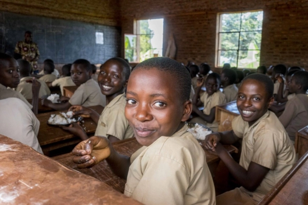 Students enjoy their lunch meal at Ecofo Gatovu school.