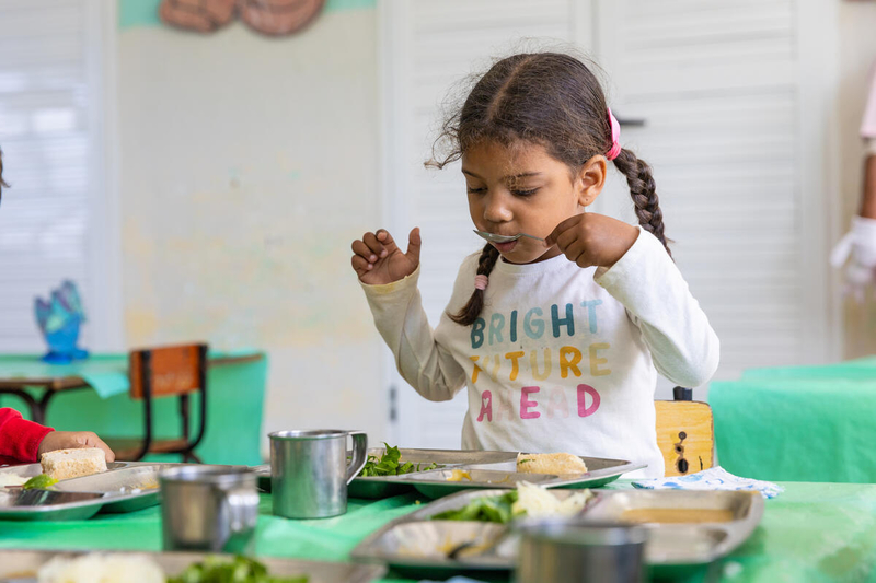 Girl eats her school meal