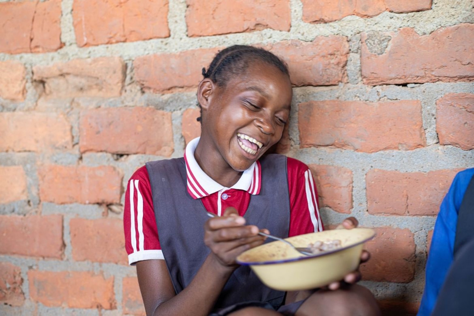 Girl enjoys her school meal in Zambia