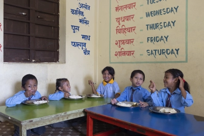 some children from Nepal share a meal cooked for them in school