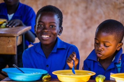 Children eating and smiling at a table