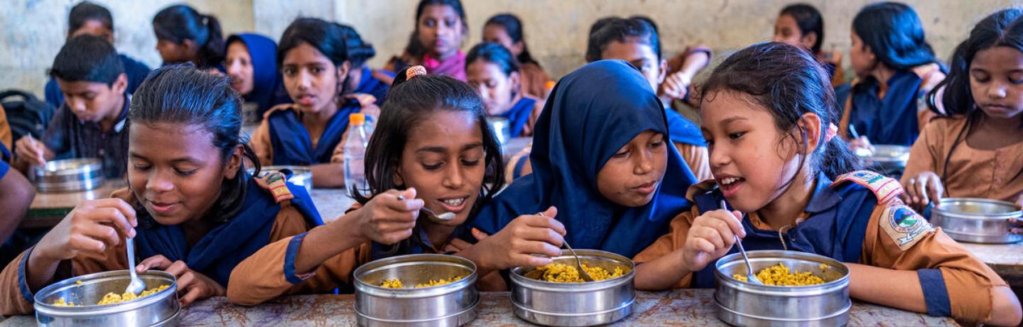 Kids having a meal together in a classroom.