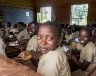A group of children sitting at desks in a classroom.