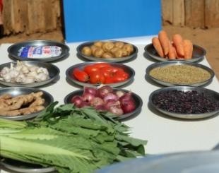 Various fresh vegetables and items displayed on a table.