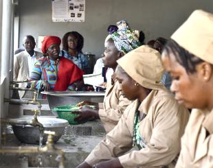 Benin's Vice President, Mariam Talata speaks to women at the rice processing centre in Bantè.