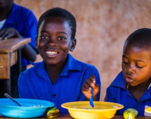Children enjoy their school lunch meal 