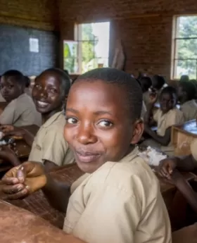 A group of children sitting at desks in a classroom.