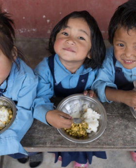 Children eating food at a school 