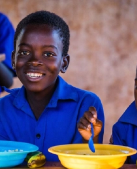 Children enjoy their school lunch meal 