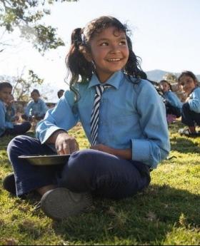 child eating school meals in nepal